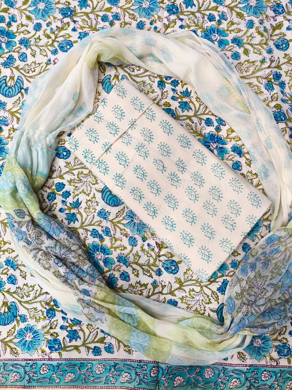 Folded fabric with blue floral patterns on a decorative background